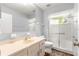 Bathroom with neutral vanity, toilet and tiled shower with glass doors at 10954 Sw 83Rd Ct, Ocala, FL 34481