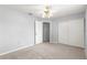 Neutral bedroom with carpeted floor, ceiling fan and open closet at 10954 Sw 83Rd Ct, Ocala, FL 34481