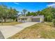 Exterior shot showcasing an attached garage, a well-kept lawn, and a welcoming facade in a suburban setting at 10954 Sw 83Rd Ct, Ocala, FL 34481