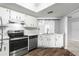 A well-lit kitchen featuring white cabinetry, modern appliances, and durable countertops at 10954 Sw 83Rd Ct, Ocala, FL 34481