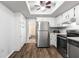 A kitchen with stainless steel appliances, white cabinets, and a skylight offering great, natural light at 10954 Sw 83Rd Ct, Ocala, FL 34481