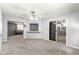 A spacious living area featuring an open layout, carpeted flooring, and seamless transitions to other living spaces at 10954 Sw 83Rd Ct, Ocala, FL 34481