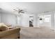 Open-concept living area with neutral paint, carpet flooring and easy access to the kitchen and other rooms at 10954 Sw 83Rd Ct, Ocala, FL 34481