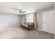 Comfortable living room with plush carpeting, a ceiling fan, and ample natural light at 10954 Sw 83Rd Ct, Ocala, FL 34481