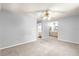 Spacious main bedroom with neutral paint, ceiling fan, carpeted flooring, and an en suite bathroom at 10954 Sw 83Rd Ct, Ocala, FL 34481