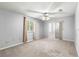 Neutral main bedroom featuring carpeted flooring, natural light, and mirrored closet doors at 10954 Sw 83Rd Ct, Ocala, FL 34481