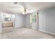 Neutral main bedroom offering carpeted flooring, a ceiling fan, and natural light from the window at 10954 Sw 83Rd Ct, Ocala, FL 34481