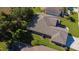 A high-angle view displays the architectural lines, a roof, and landscaping elements of the property at 13968 Se 96Th Cir, Summerfield, FL 34491