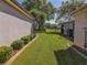 A manicured backyard features lush green grass and mature landscaping for privacy at 13968 Se 96Th Cir, Summerfield, FL 34491