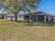 A beautiful screened-in porch and well-maintained lawn make the backyard a relaxing outdoor space at 13968 Se 96Th Cir, Summerfield, FL 34491