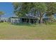 Spacious screened lanai overlooking the lush green yard, providing an ideal outdoor living space at 13968 Se 96Th Cir, Summerfield, FL 34491