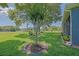 Backyard with a lush green lawn, featuring mature landscaping that surrounds the house, creating a natural and private space at 13968 Se 96Th Cir, Summerfield, FL 34491