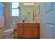 A full bathroom with a toilet, shower, and wood vanity at 13968 Se 96Th Cir, Summerfield, FL 34491