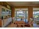 Charming breakfast nook with hardwood floors, views of the backyard, and a china cabinet at 13968 Se 96Th Cir, Summerfield, FL 34491