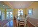 The dining room features hardwood floors, a chandelier, and direct access to the front entry at 13968 Se 96Th Cir, Summerfield, FL 34491