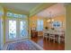 Dining room featuring a decorative entry door, chandelier and seating for six at 13968 Se 96Th Cir, Summerfield, FL 34491