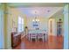 The dining room features hardwood floors, a chandelier, and direct access to the front entry at 13968 Se 96Th Cir, Summerfield, FL 34491