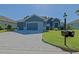 A charming residence that includes a lush lawn, appealing curb appeal, and a convenient brick driveway at 13968 Se 96Th Cir, Summerfield, FL 34491