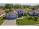 Aerial view of a well-maintained one story home with lush green lawn and surrounding landscaping at 13968 Se 96Th Cir, Summerfield, FL 34491