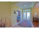 The foyer features high ceilings, tiled flooring and stained glass windows in the double door entryway at 13968 Se 96Th Cir, Summerfield, FL 34491