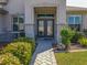 Close up of the front door featuring decorative glass, columns and landscaping at 13968 Se 96Th Cir, Summerfield, FL 34491