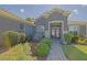 Inviting front entrance with decorative glass doors, a paved walkway, and lush landscaping that enhances curb appeal at 13968 Se 96Th Cir, Summerfield, FL 34491