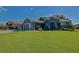 Charming single Gathering home featuring a lush green lawn, professional landscaping, and inviting curb appeal at 13968 Se 96Th Cir, Summerfield, FL 34491