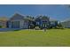 Beautiful single Gathering home showcasing manicured lawn, complemented by lush landscaping and a neutral color palette at 13968 Se 96Th Cir, Summerfield, FL 34491