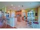 Eat-in kitchen with granite counters, a center island, and a dining area for casual meals at 13968 Se 96Th Cir, Summerfield, FL 34491