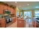 Well-equipped kitchen with granite countertops, stainless steel appliances, and a breakfast nook nearby at 13968 Se 96Th Cir, Summerfield, FL 34491