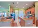 Spacious kitchen featuring granite countertops, modern appliances, and an island for food preparation at 13968 Se 96Th Cir, Summerfield, FL 34491