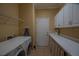Functional laundry room with washer, dryer, white cabinets and ample counter space for folding and storage at 13968 Se 96Th Cir, Summerfield, FL 34491