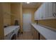 Functional laundry room with washer, dryer, white cabinets and ample counter space for folding and storage at 13968 Se 96Th Cir, Summerfield, FL 34491