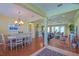An open-concept living and dining area features hardwood floors and plenty of space for Gathering and friends at 13968 Se 96Th Cir, Summerfield, FL 34491