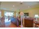 Open-concept living room with hardwood floors, ample natural light, and comfortable seating arrangement at 13968 Se 96Th Cir, Summerfield, FL 34491