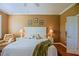 The main bedroom features a ceiling fan, wood floors and neutral walls at 13968 Se 96Th Cir, Summerfield, FL 34491