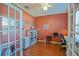 Comfortable home office featuring French doors, wood floors, and a workspace with desk and chair at 13968 Se 96Th Cir, Summerfield, FL 34491