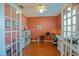 An office featuring laminate floors, French doors, and bright natural light at 13968 Se 96Th Cir, Summerfield, FL 34491