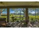 Enclosed patio offering views of the green landscape and stylish décor at 13968 Se 96Th Cir, Summerfield, FL 34491
