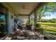 Screened-in patio offering a relaxing seating area and view of the expansive backyard at 13968 Se 96Th Cir, Summerfield, FL 34491