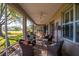 Spacious screened-in patio with comfortable seating and peaceful backyard views at 13968 Se 96Th Cir, Summerfield, FL 34491