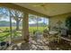 Covered patio with brick flooring, screened windows, and dining, perfect for outdoor dining at 13968 Se 96Th Cir, Summerfield, FL 34491