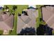 Overhead view showcasing a well-maintained roof with clean lines and a neatly kept surrounding yard at 13968 Se 96Th Cir, Summerfield, FL 34491