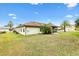 The home's exterior has a lovely yard with beautiful trees, a screen enclosed lanai, and nice curb appeal at 12240 Se 172Nd Ln, Summerfield, FL 34491