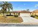 Charming single-story home with well-manicured lawn, mature trees, and an attached two-car garage at 12240 Se 172Nd Ln, Summerfield, FL 34491