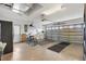 Garage featuring epoxy floors, a refrigerator, bikes, and a garage door with colorful storage supports at 12240 Se 172Nd Ln, Summerfield, FL 34491