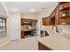 Modern kitchen featuring stainless steel appliances, tiled floors, and dark wood cabinets at 12240 Se 172Nd Ln, Summerfield, FL 34491
