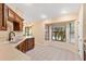 Bright and airy kitchen with tile floors, plenty of counter space, and view to sliding glass doors at 12240 Se 172Nd Ln, Summerfield, FL 34491