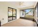 This is a beautiful screened lanai, with a neutral floor, that looks out to the yard and adjacent homes at 12240 Se 172Nd Ln, Summerfield, FL 34491