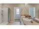 Bright bathroom with double vanity, modern fixtures, and a separate shower area, creating a spa-like retreat at 23 Hickory Crse, Ocala, FL 34472